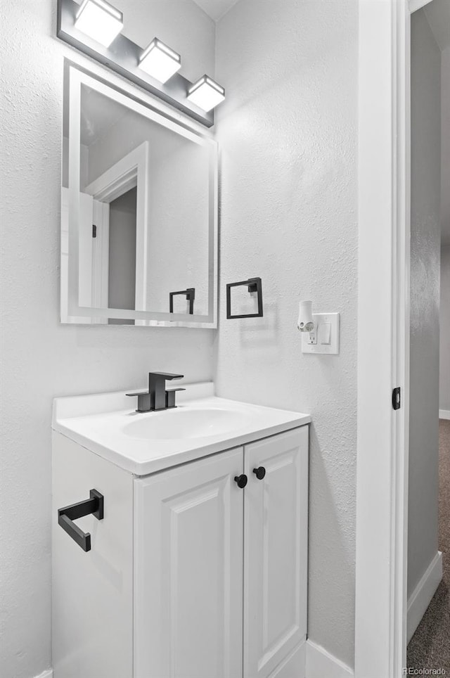 4672 S Lewiston Way, Aurora, CO 80015 - bathroom with vanity and baseboards