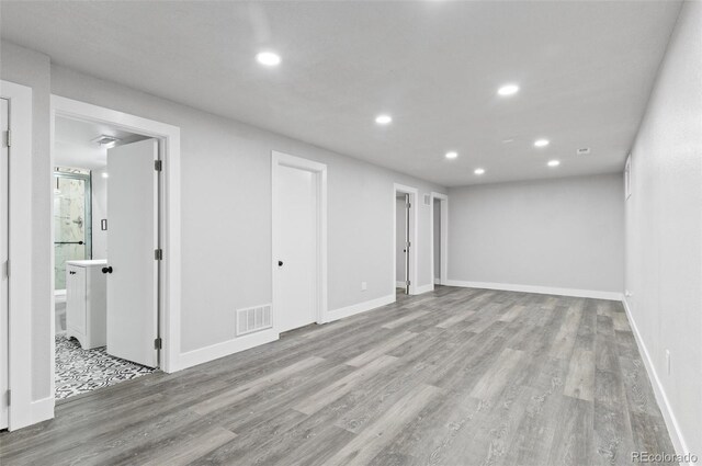 4672 S Lewiston Way, Aurora, CO 80015 - below grade area with recessed lighting, wood finished floors, and baseboards