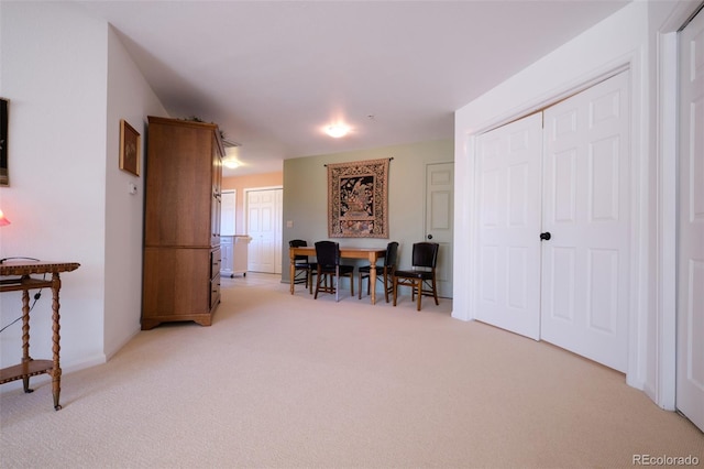 dining space with light colored carpet