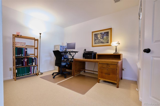 carpeted home office featuring baseboards