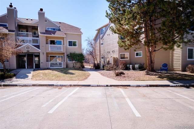 exterior space with uncovered parking and cooling unit