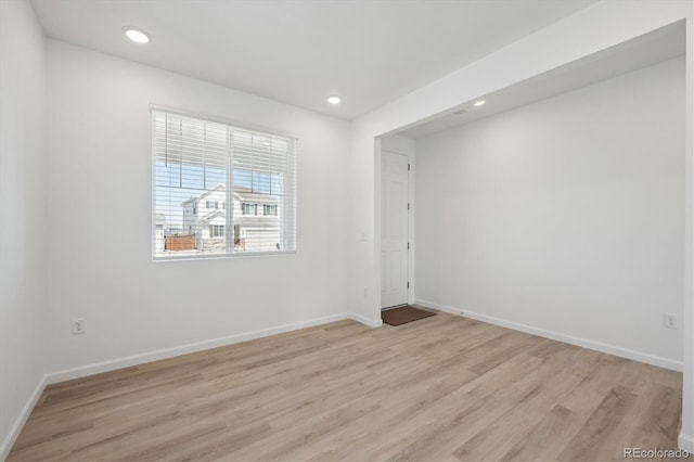 unfurnished room with recessed lighting, baseboards, and light wood-style floors