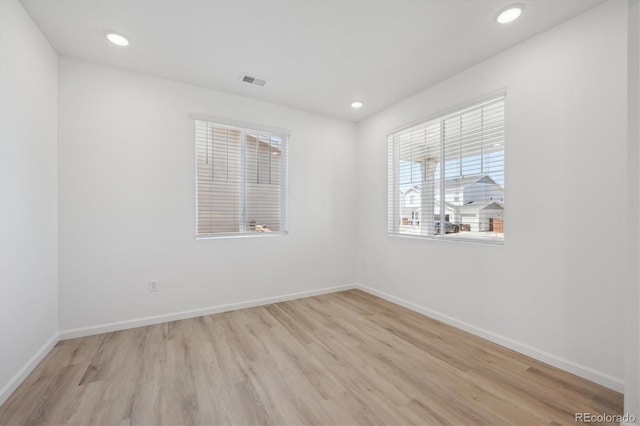 spare room with recessed lighting, baseboards, visible vents, and light wood-style floors