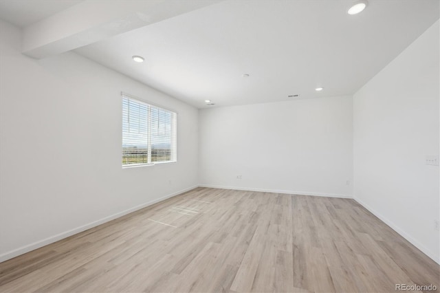 spare room with visible vents, light wood-style flooring, baseboards, and recessed lighting