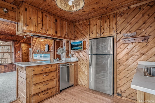 kitchen with brown cabinets, stainless steel appliances, and light countertops