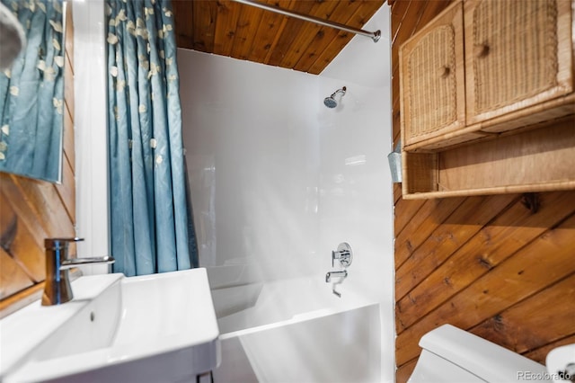 full bathroom featuring wood ceiling, a sink, toilet, and shower / bath combo with shower curtain