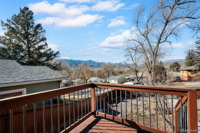 wooden terrace featuring a residential view and a mountain view