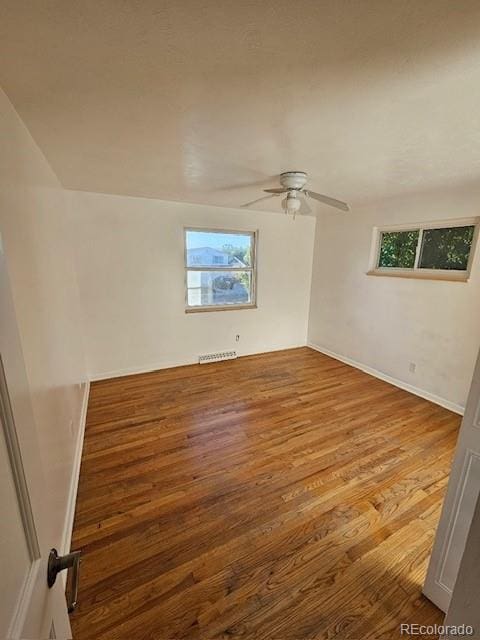 empty room featuring ceiling fan, light hardwood / wood-style flooring, and a healthy amount of sunlight