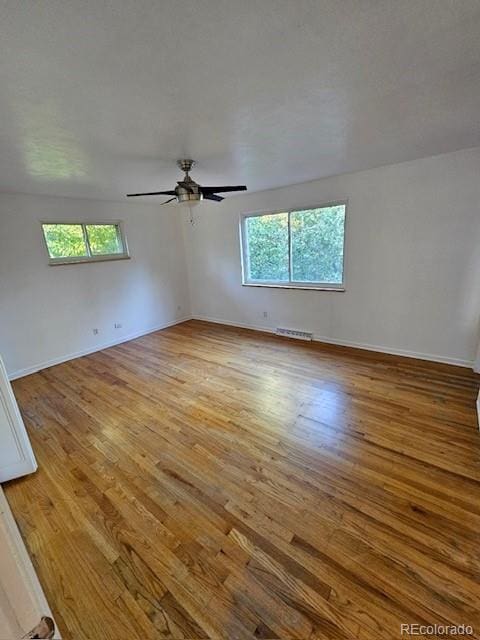 unfurnished room featuring light hardwood / wood-style flooring, ceiling fan, and plenty of natural light