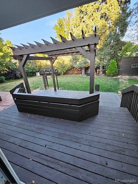 wooden terrace with a yard and a pergola