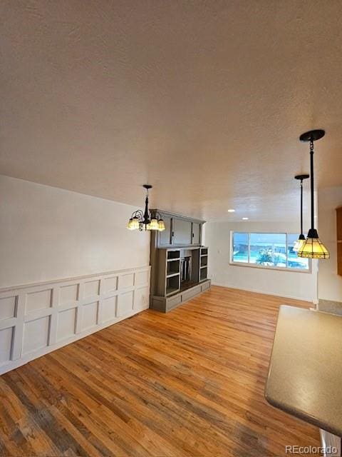 interior space with a notable chandelier and hardwood / wood-style floors