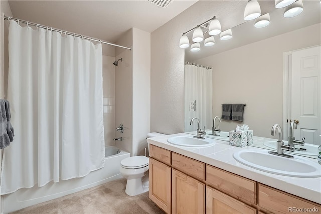 full bathroom with double vanity, shower / bath combination with curtain, toilet, and a sink