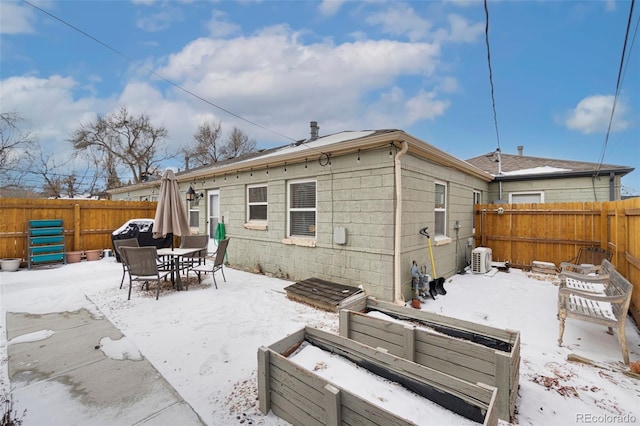 view of snow covered rear of property