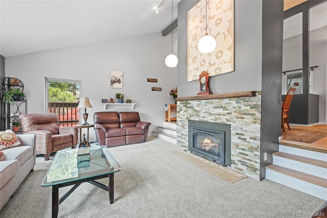 carpeted living room with stairway, high vaulted ceiling, and a tile fireplace