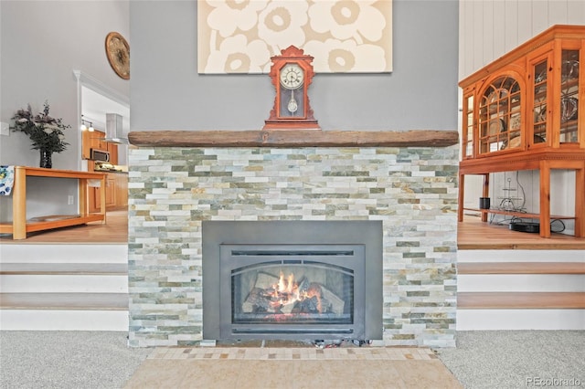 room details featuring carpet flooring, stainless steel microwave, and a tile fireplace