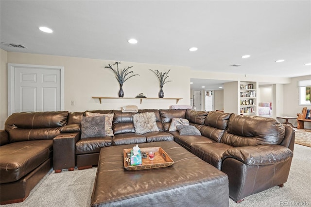carpeted living area with recessed lighting and visible vents
