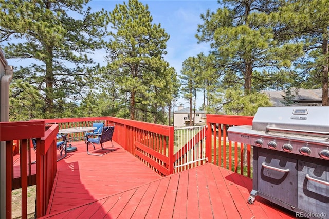 wooden terrace featuring a grill