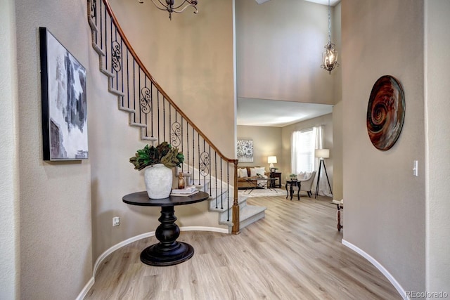 7329 Arco Iris Ln, Castle Pines, CO 80108 - entryway with wood finished floors, stairs, and a towering ceiling