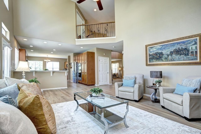 7329 Arco Iris Ln, Castle Pines, CO 80108 - living area featuring ceiling fan, a towering ceiling, light wood-style floors, and recessed lighting