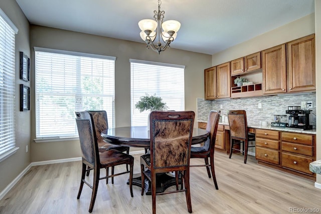 7329 Arco Iris Ln, Castle Pines, CO 80108 - dining space featuring light wood-style flooring and a chandelier