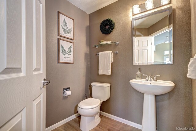 7329 Arco Iris Ln, Castle Pines, CO 80108 - bathroom with wood finished floors and toilet