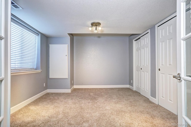 7329 Arco Iris Ln, Castle Pines, CO 80108 - unfurnished bedroom featuring carpet flooring, two closets, and a textured ceiling