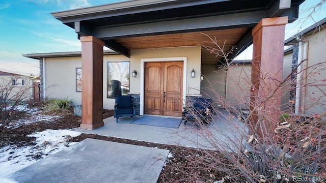 view of snow covered property entrance