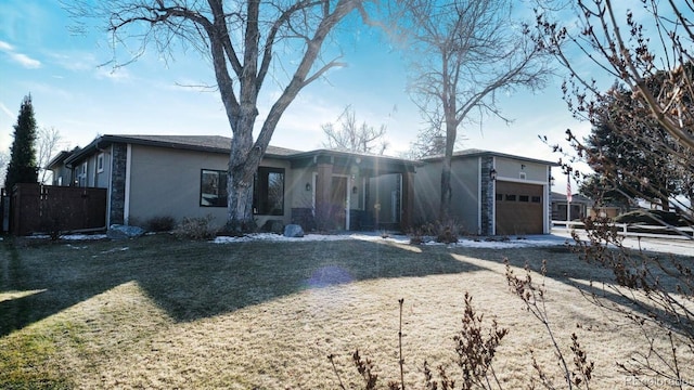 view of front facade with a front yard and a garage