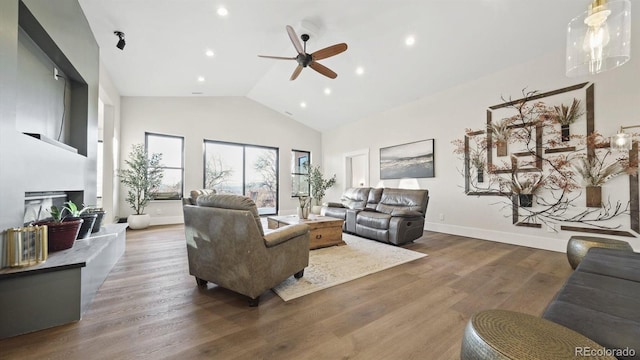 living room with ceiling fan, dark hardwood / wood-style flooring, and lofted ceiling