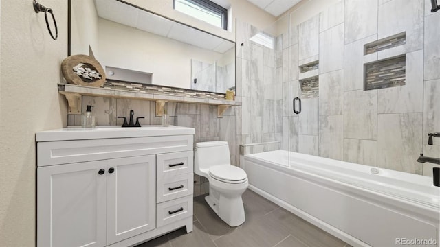 bathroom with enclosed tub / shower combo, vanity, toilet, and tile patterned floors