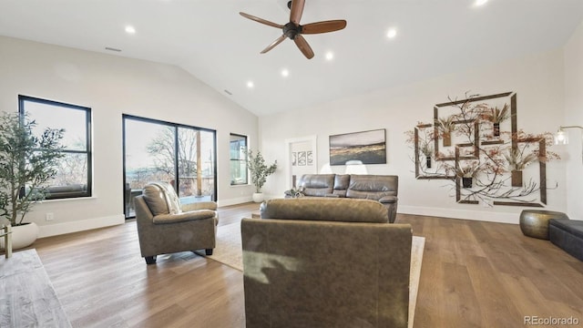 living area featuring ceiling fan, high vaulted ceiling, recessed lighting, wood finished floors, and baseboards