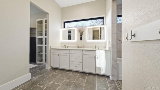 bathroom featuring double vanity and a sink