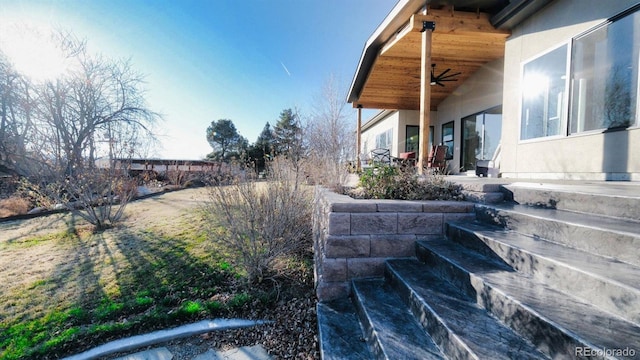 view of yard featuring a ceiling fan and a patio area