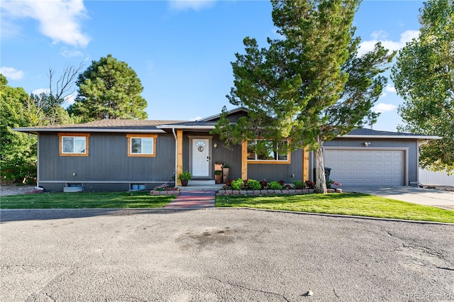 view of front of property with a front yard and a garage