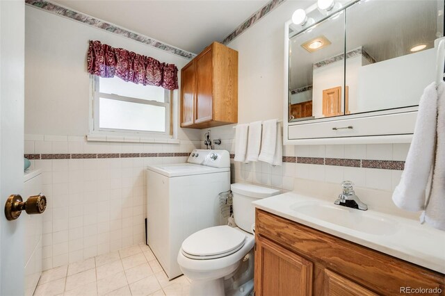 359 S 25th Ave, Brighton, CO 80601 - bathroom with washer / clothes dryer, tile walls, toilet, vanity, and tile patterned flooring