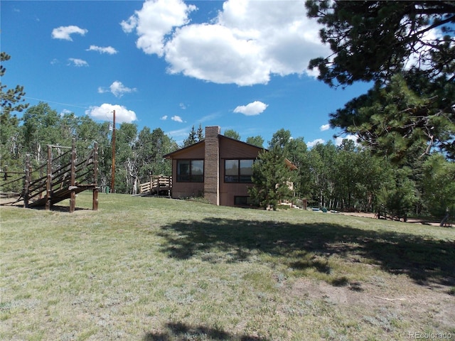 171 Broken Wagon Rd, Woodland Park, CO 80863 - view of green lawn featuring stairs