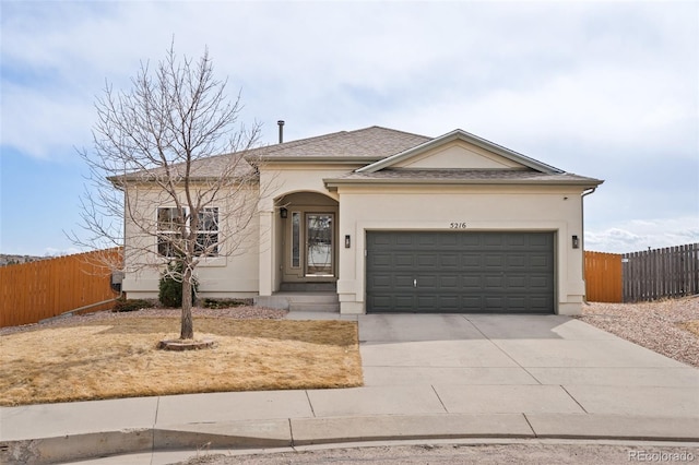 ranch-style house featuring a garage, a shingled roof, concrete driveway, fence, and stucco siding