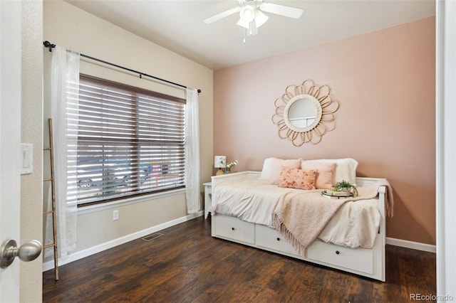 bedroom featuring a ceiling fan, visible vents, baseboards, and wood finished floors