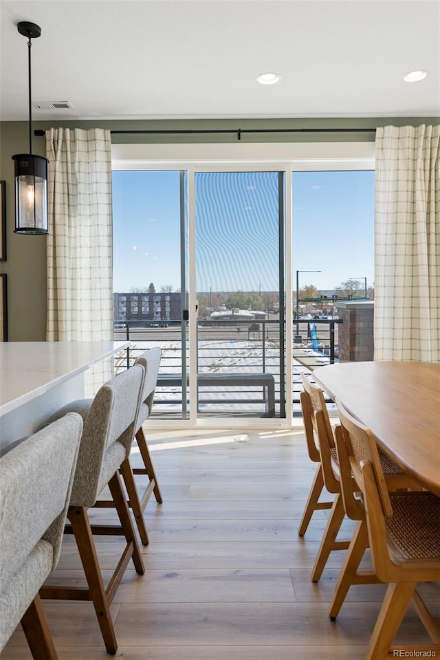 dining space with light hardwood / wood-style floors