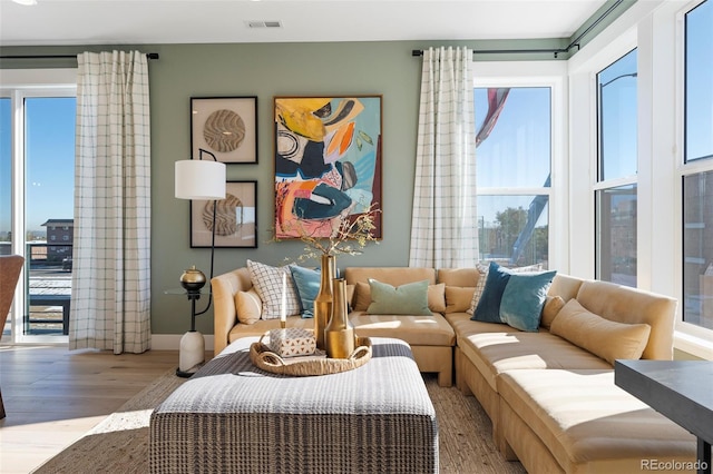 sitting room featuring plenty of natural light and light hardwood / wood-style floors