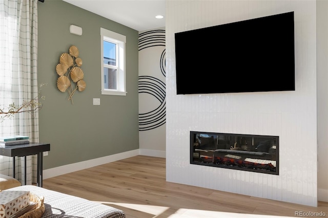 interior space with a fireplace and hardwood / wood-style floors