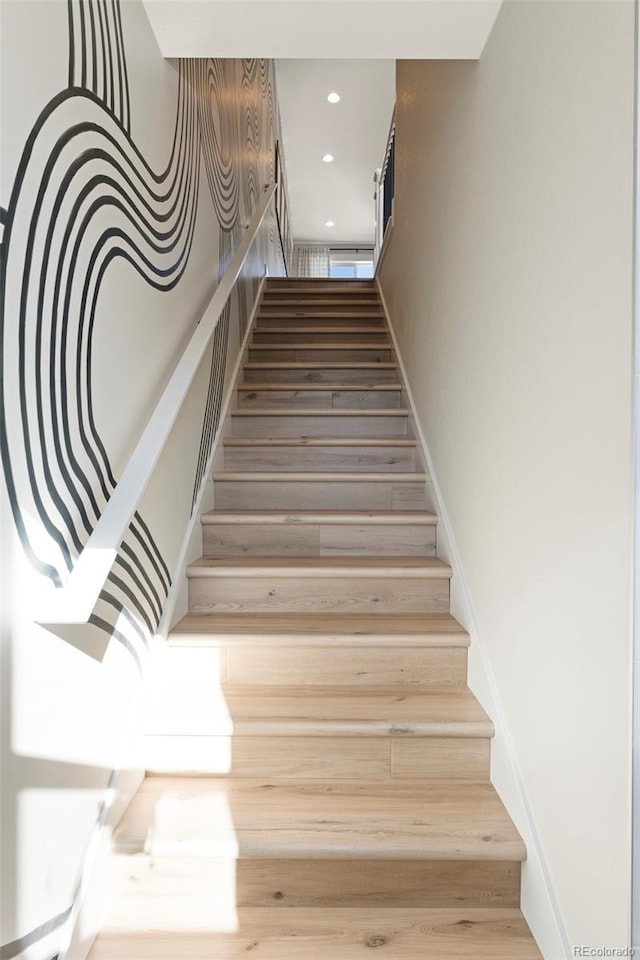 stairway featuring hardwood / wood-style floors