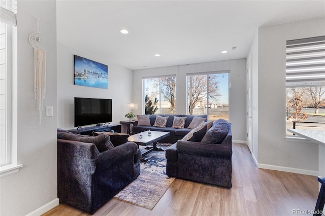 living room with baseboards, wood finished floors, and recessed lighting