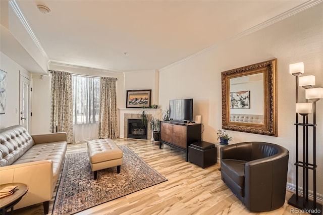 living room featuring a tiled fireplace, hardwood / wood-style flooring, and ornamental molding