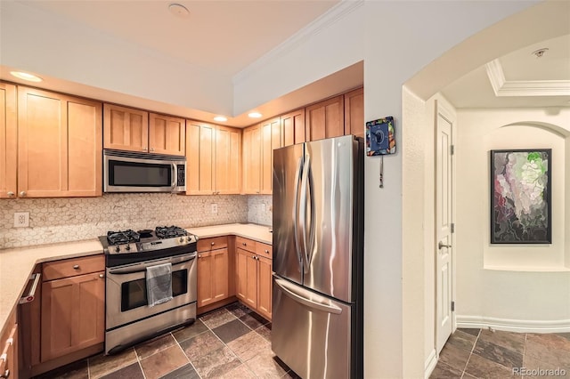 kitchen with tasteful backsplash, crown molding, and appliances with stainless steel finishes