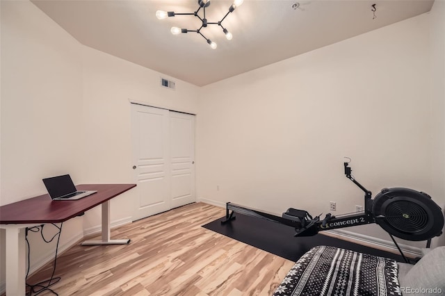 exercise area with light hardwood / wood-style floors