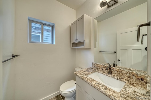 bathroom with toilet and vanity