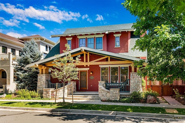 11776 Perry St, Westminster, CO 80031 - view of front of house with fence, stucco siding, a porch, and stone siding