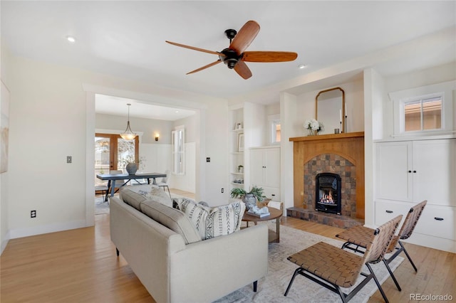 11776 Perry St, Westminster, CO 80031 - living room featuring ceiling fan, a stone fireplace, light wood-style flooring, recessed lighting, and baseboards