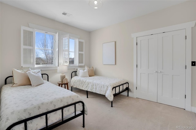 11776 Perry St, Westminster, CO 80031 - bedroom featuring visible vents, baseboards, a closet, and light carpet